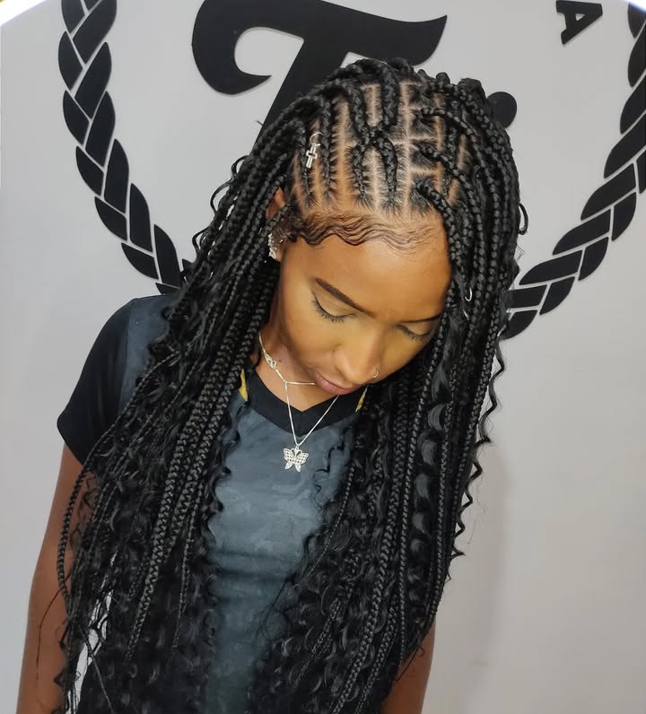 Close-up of a woman with flip-over Fulani braids, featuring knotless braids and cornrows, styled elegantly with hair accessories.